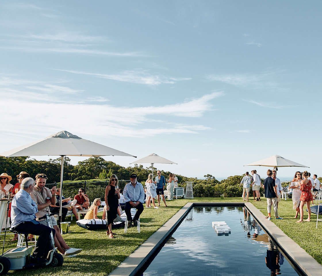 Guests at an outdoor event beside a pool